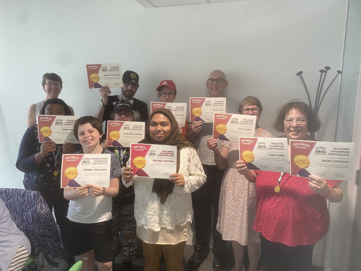 A group of people holding certificates and smiling at the camera